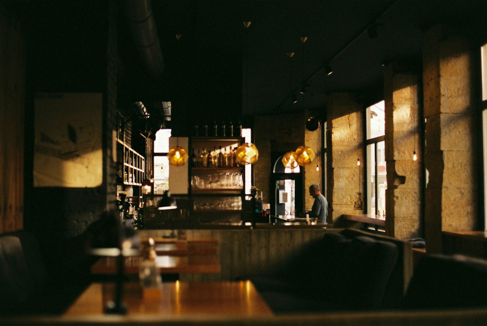 Dimly lit restaurant interior with set tables