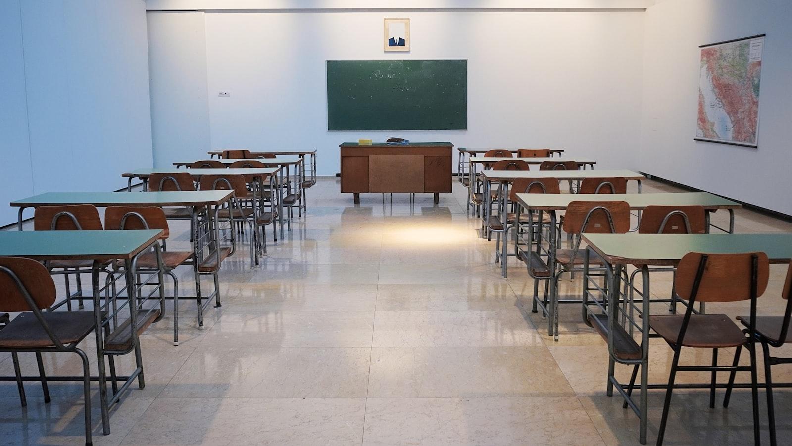 Empty classroom with rows of desks and a chalkboard